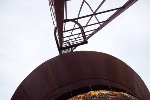 Rusty water tower against the sky. Old water pump.