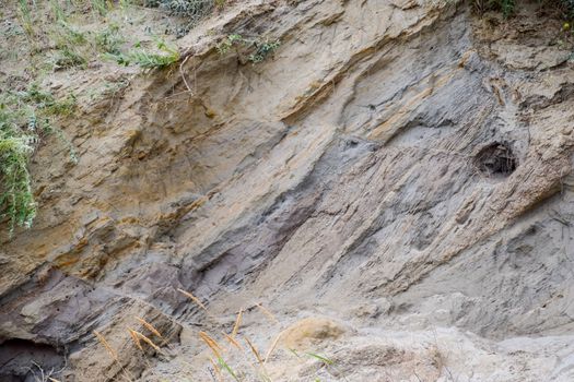 The sedimentary layers of the rock in the sand scree. sand, pebbles and shells in sedimentary rocks.