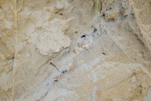 The sedimentary layers of the rock in the sand scree. sand, pebbles and shells in sedimentary rocks.