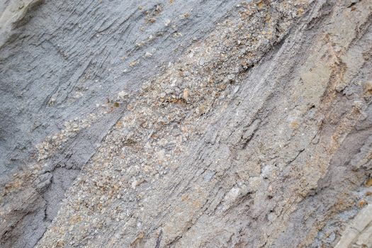 The sedimentary layers of the rock in the sand scree. sand, pebbles and shells in sedimentary rocks.