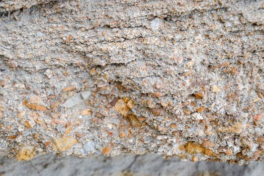 The sedimentary layers of the rock in the sand scree. sand, pebbles and shells in sedimentary rocks.