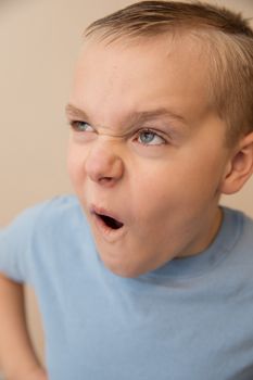 Boy having a fun time by making crazy weird faces