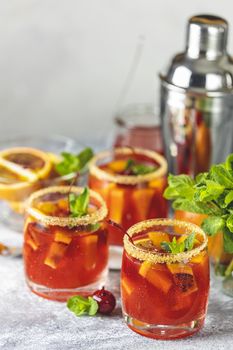 Italian aperol spritz cocktail with orange slices and ingredients on light gray stone table. Milano spritzer alcoholic cocktail with red bitter, dry white wine, soda, red orange and ice. 