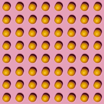 Orange pattern on pink background. Creative food concept. Flat lay.