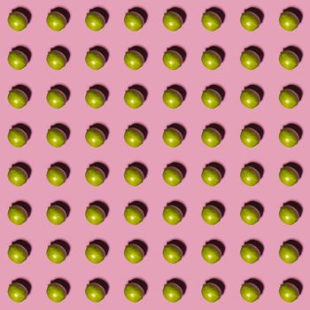 Limes pattern on pink background. Creative food concept. Flat lay.