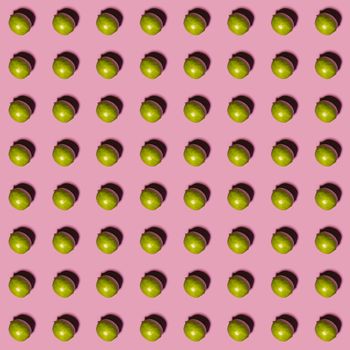 Limes pattern on pink background. Creative food concept. Flat lay.