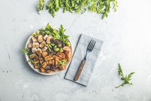 Healthy food. Plate of baking chicken meat, fried sweet potato and brussels sprouts. Top view, light gray concrete surface, flat lay.
