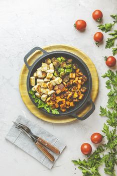 Healthy food. Pan of baking chicken meat, fried sweet potato and brussels sprouts. Top view, light gray concrete surface, flat lay.	