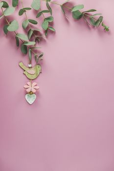 Eucalyptus leaves on pink background. Frame made of eucalyptus branches. Valentine's day, Mother's day, Happy Easter, Womans Day concept. Flat lay, top view, copy space