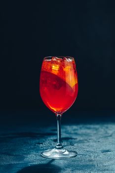 Cocktail aperol spritz on dark background.. Sunlight. Summer alcohol cocktail with orange slices. Italian cocktail aperol spritz on slate board. Trendy beverage