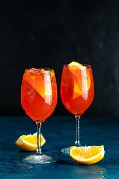 Two Aperol spritz cocktail in big wine glass with water drops, summer Italian fresh alcohol cold drink, close up	