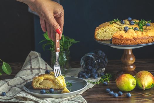 Delicious dessert blueberry tart with fresh berries and pears, sweet tasty cheesecake, berry pie. French cuisine Artistic Still Life in the style of Dutch painting. Copy space for you text