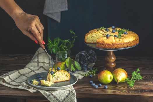 Delicious dessert blueberry tart with fresh berries and pears, sweet tasty cheesecake, berry pie. French cuisine Artistic Still Life in the style of Dutch painting. Copy space for you text