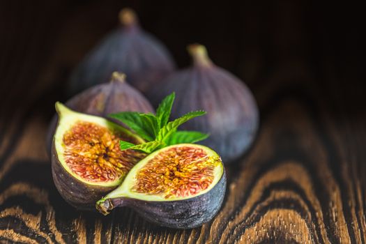 Ripe Fig Fruits on old wooden background. Paleo diet, still life with copy space. Shallow depth of the field.