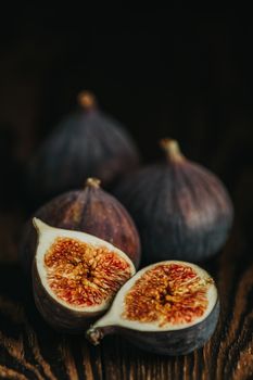 Ripe Fig Fruits on old wooden background. Paleo diet, still life with copy space. Shallow depth of the field.