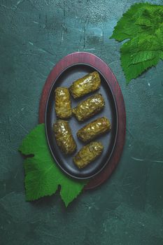 Traditional Middle Eastern dolma or tolma or sarma. Latin American Mexican Chilean cuisine ninos envueltos. Grape leaves stuffed with meat and rice. Lebanon turkish greek middle eastern cuisine.