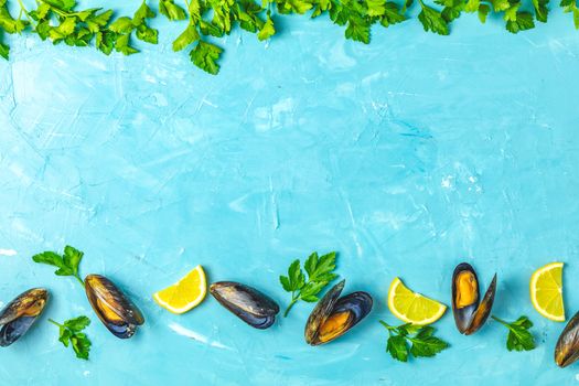 Seafood mussels with lemon and parsley on light blue concrete table surface, top view, copy space for you text, food background