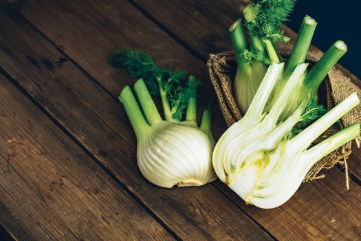 Fresh Florence fennel bulbs or Fennel bulb on wooden background. Healthy and benefits of Florence fennel bulbs