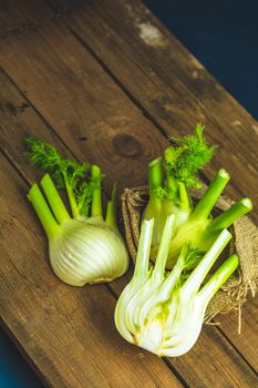 Fresh Florence fennel bulbs or Fennel bulb on wooden background. Healthy and benefits of Florence fennel bulbs