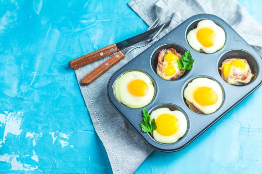 Baked eggs  in baking molds. Portioned casserole from bacon sowbelly and eggs in Italian style.