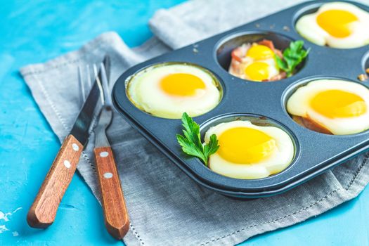 Baked eggs  in baking molds. Portioned casserole from bacon sowbelly and eggs in Italian style.