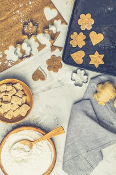 Culinary Spring or Christmas food background. Ingredients for ginger cookies. Dough for baking, brown sugar, flour, eggs. View from above.