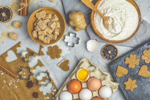 Culinary Spring or Christmas food background. Ingredients for ginger cookies. Dough for baking, brown sugar, flour, eggs. View from above.