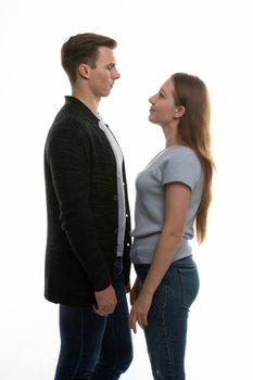 a young man and a girl stand opposite each other