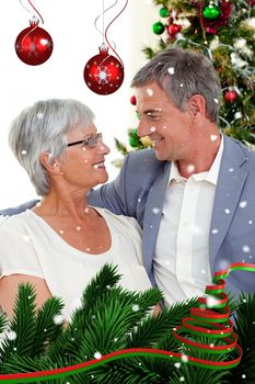 Senior couple in love in Christmas against snow falling