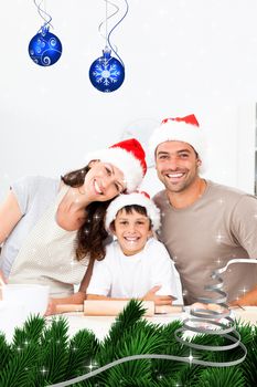 Happy family baking christmas cookies together against twinkling stars
