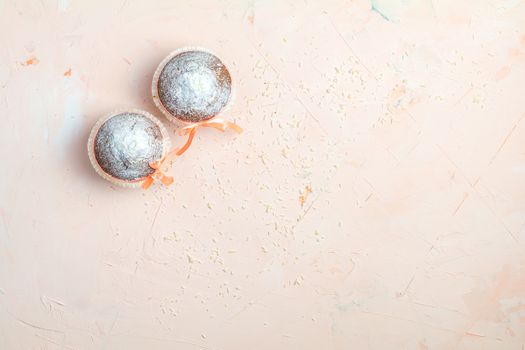 Tasty delicious homemade muffin on light pink living coral stone concrete surface, top view, copy space.