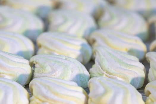 Background or texture of colorful marshmallows on light table background. Shallow depth of the field.