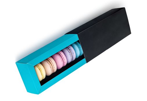 Macaroons in gift box top view on white background