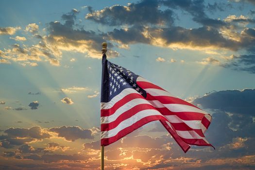 American Flag blowing in the wind at the top of a flagpole