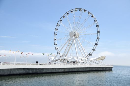 The Baku Ferris wheel is a 60-meter-high Ferris wheel located in the capital of Azerbaijan, in the city of Baku, in the new tabloid part of the marine national park stretching to the national flag area.