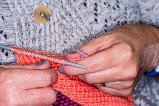 close up a woman knitting a jumper in UK