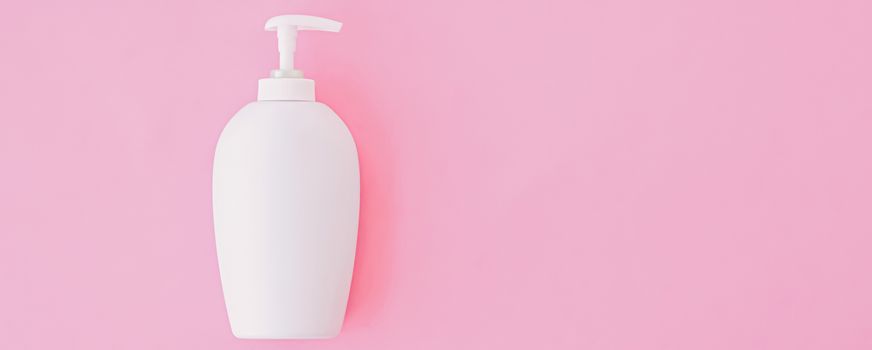 Bottle of antibacterial liquid soap and hand sanitizer on pink background, hygiene product and healthcare, flatlay