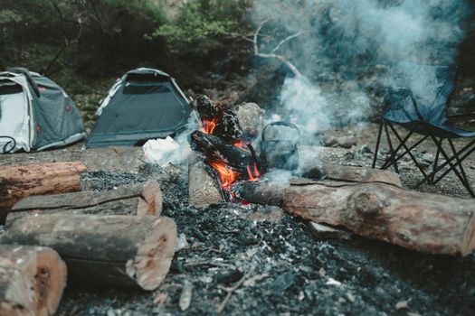 Small camp with smoke from campfire by waterfall in Eksili, Antalya, Turkey.