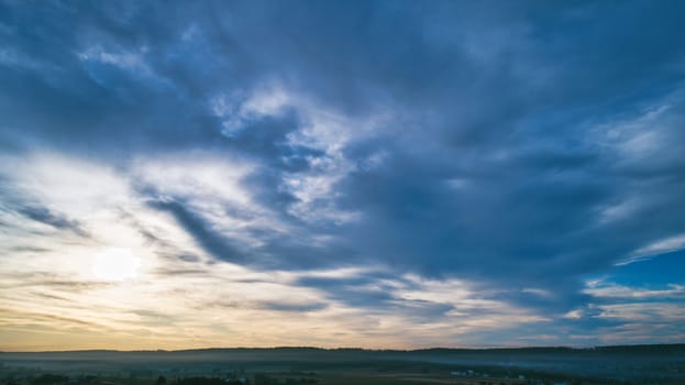Aerial View of a Late Afternoon Sun With Partly Cloudy Blue Sky Over Farm Countryside Background