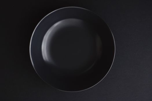 Empty plates on black background, premium dishware for holiday dinner, minimalistic design and diet concept