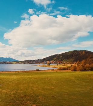 Beautiful nature of European Alps, landscape view of alpine mountains, lake and village in autumn season, travel and destination scenery