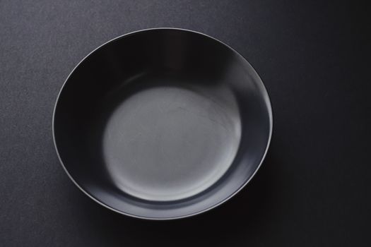 Empty plates on black background, premium dishware for holiday dinner, minimalistic design and diet concept