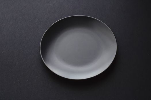 Empty plates on black background, premium dishware for holiday dinner, minimalistic design and diet concept