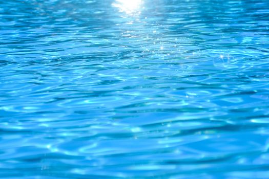 Swimming pool water, natural abstract background with sunlights