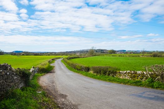 Mother and choildren walk on country rural road