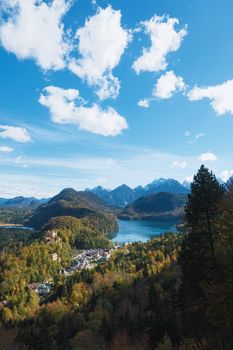 Beautiful nature of European Alps, landscape view of alpine mountains, lake and village on a sunny day, travel and destination scenery