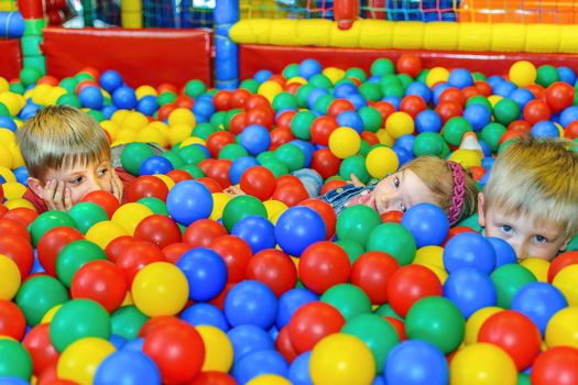 Children playing in a ball pool at the party.