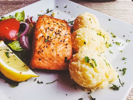 Grilled salmon, mashed potatoes and salad for lunch, served meal