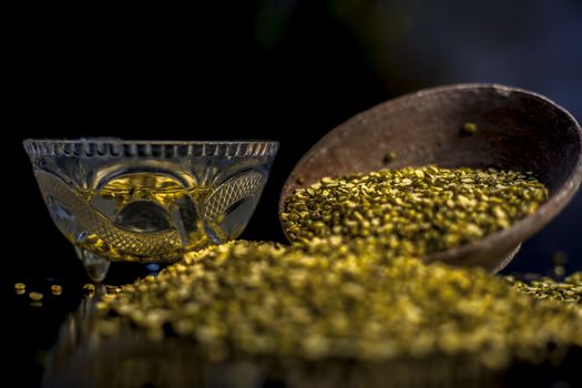 Close shot of mung bean or moong dal in a clay bowl along with some water and moong dal well mixed on a black glossy surface. Horizontal shot with Rembrandt lighting technique.