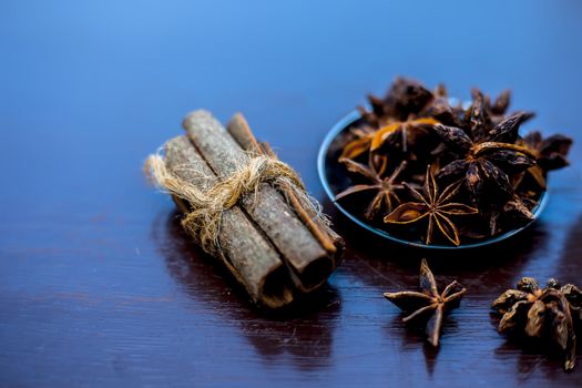 Face mask for wrinkles on the wooden surface consisting of some cinnamon sticks, water, and star anise seed powder.